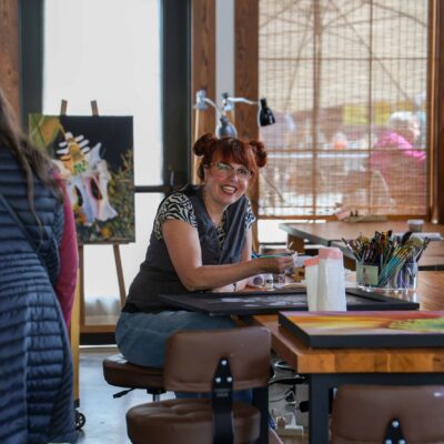 Brandi painting in her studio (Brandi Dayton Art) at Columbia Gardens.