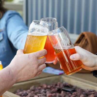 A group on the patio at Wheat Head on the Water clinking glasses.