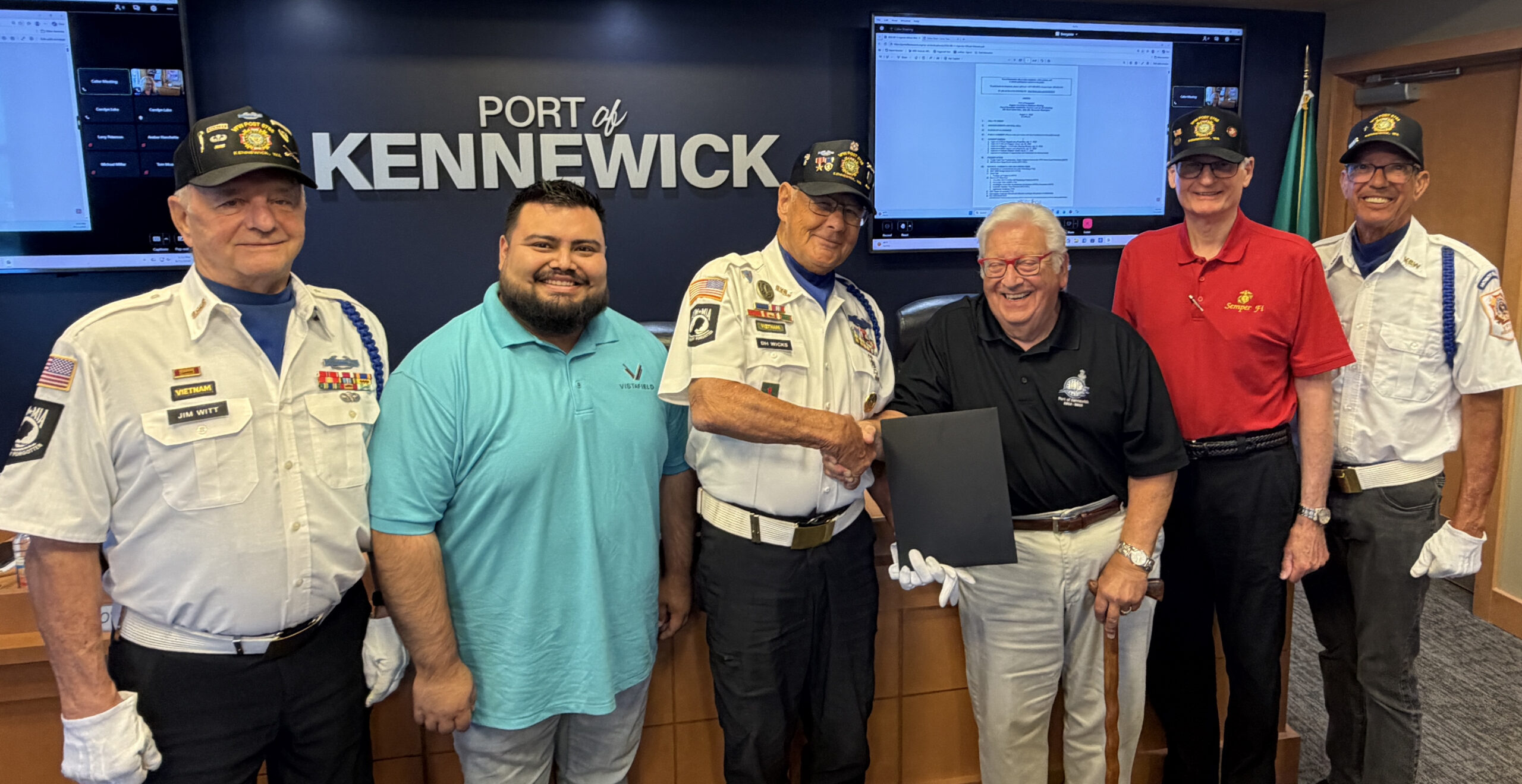 Port of Kennewick Commissioners Skip Novakovich (third from right) and Raul Contreras Gonzalez (second from left) present the proclamation to Purple Heart recipient and Army veteran Don Wicks (center) and other members of local VFW Post 5785 (from left) Army veteran Jim Witt, Marine veteran Kevin Veleke and Navy veteran Mike Dotson.