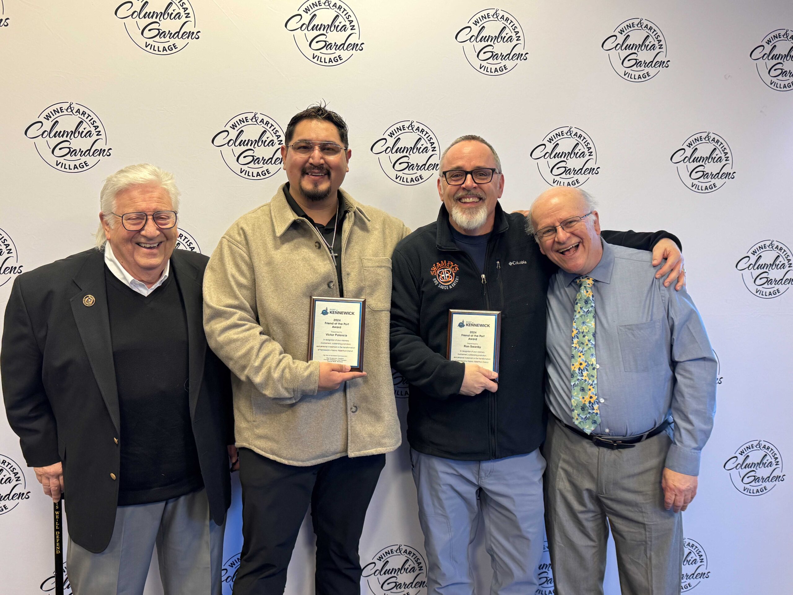 Port of Kennewick Commissioners Skip Novakovich (left) and Thomas Moak (right) stand with 2024 “Friends of the Port” Award honorees Victor Palencia (center left) and Ron Swanby.