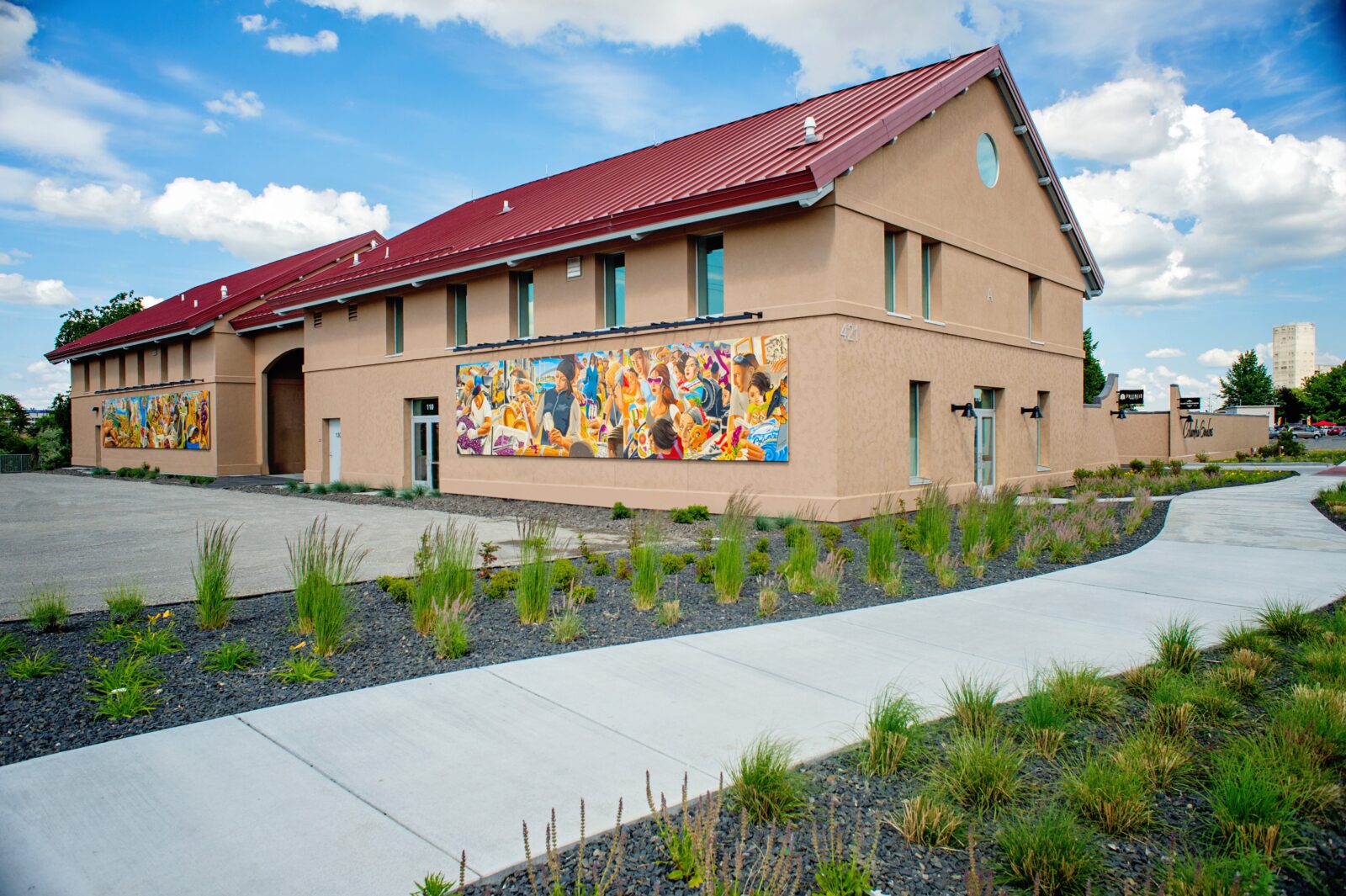 An exterior of the phase 1 winery building at Columbia Gardens with the Mid-Columbia Latino Heritage Mural spanning two of the walls.