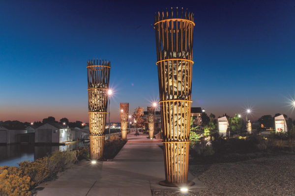 Spotlights illuminate the Sapáxikas “Willow Fish Traps” artwork structures.