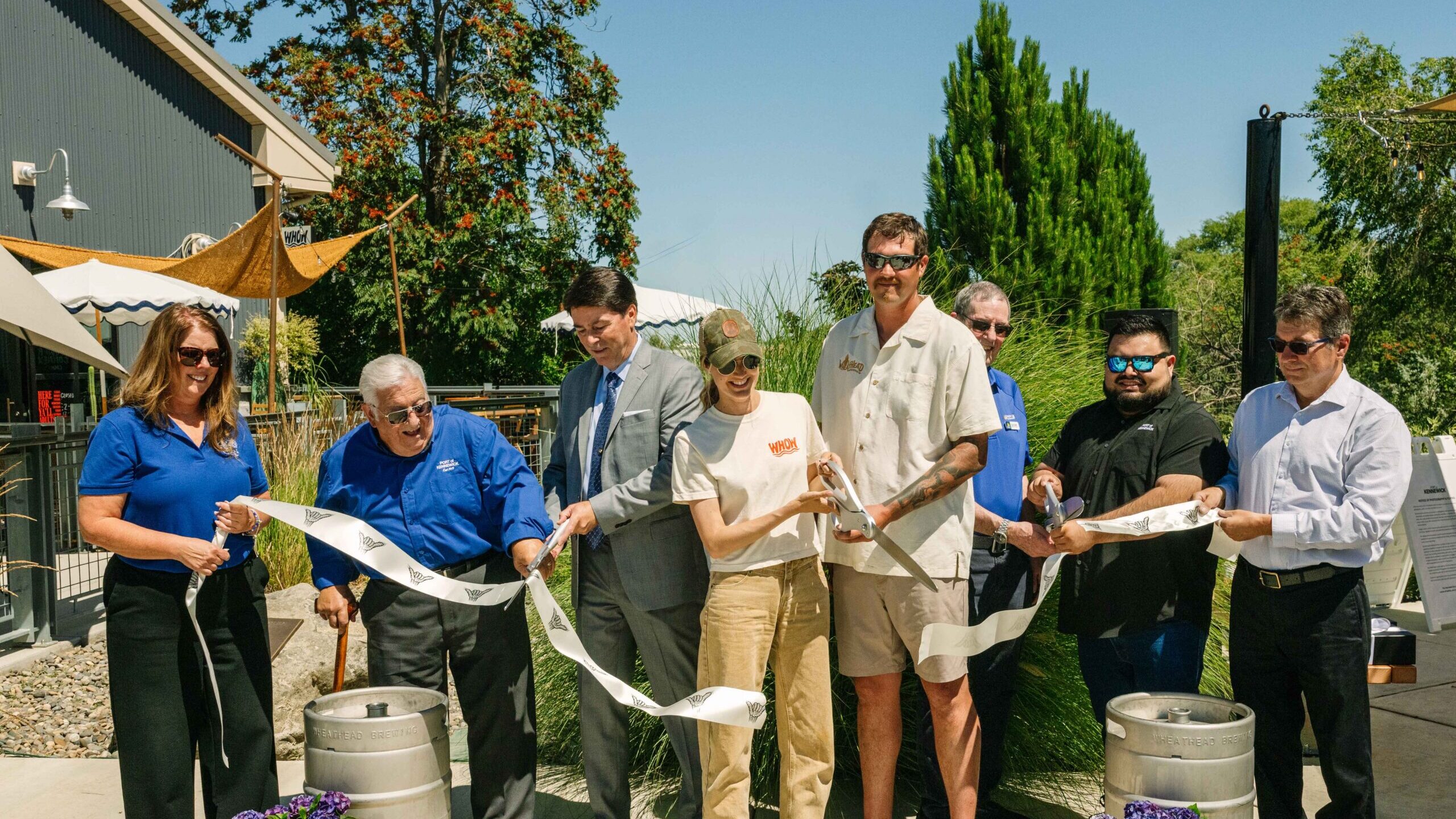 Port Commissioners and staff join the co-owner and family to cut a ceremonial ribbon at the Grand Opening Celebration for Wheat Head on the Water at Columbia Gardens.