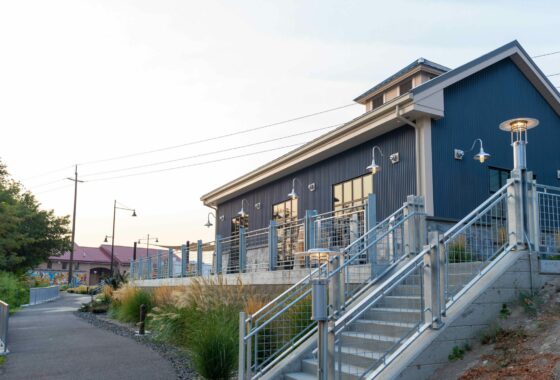 Exterior of a tasting room building at Columbia Gardens overlooking the pathway and interior waterfront.