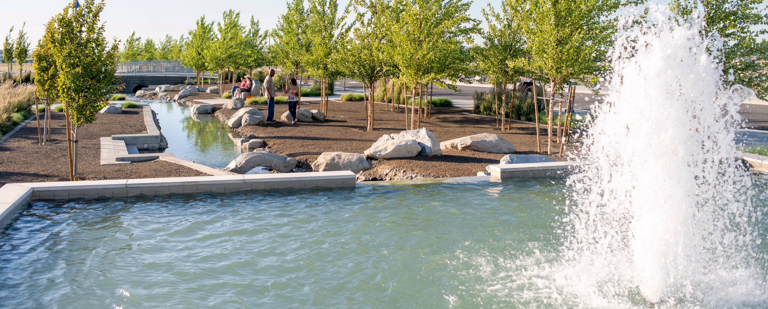 People visiting next to Vista Field's water features.